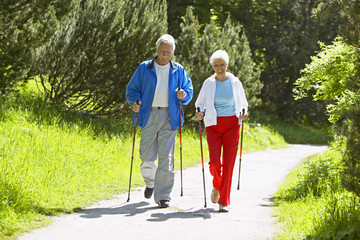 Senior couple doing Nordic walking - obrazy, fototapety, plakaty