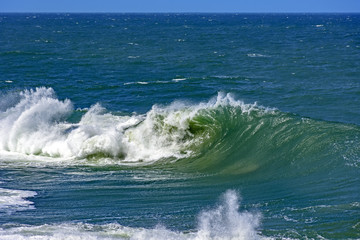 Big, dangerous waves during tropical storm in the green and blue waters of Rio de Janeiro, Brazil