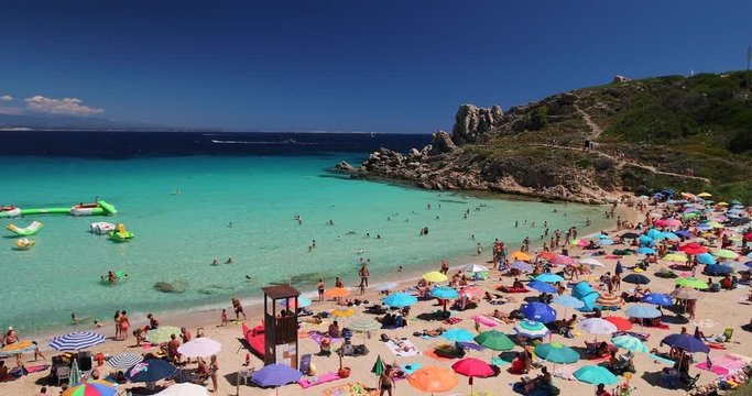 Spiaggia di Rena Bianca beach with red rocks and azure clear water, Santa Terasa Gallura, Sardinia, Italy.