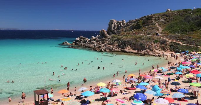 Spiaggia di Rena Bianca beach with red rocks and azure clear water, Santa Terasa Gallura, Sardinia, Italy.