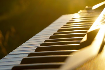 Keyboard of an old electric piano on the sunset