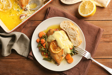 Delicious chicken breast with lemon and vegetables on plate