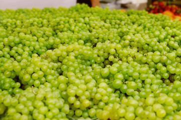 Tasty fresh grapes at market, closeup