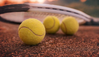 Tennis ball with racket on the tennis court. Sport, recreation concept