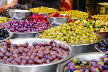 Fototapeta na wymiar Different fresh olives in bowls at market