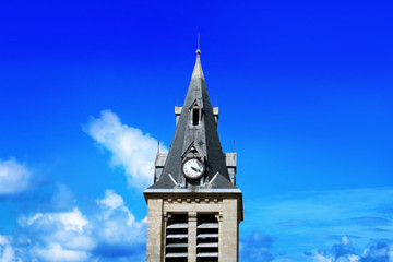 Beautiful city tower with clock on blue sky background