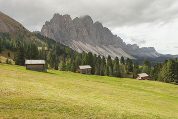 old hayloft in a pasture in Val di Funes at fall ( Dolomites - Odle group in the background )