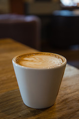 a cup of cappuccino in caffe store