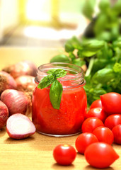 Tomato sauce and Italian basil in a glass jar