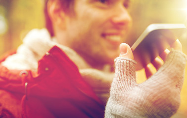 close up of man recording voice on smartphone
