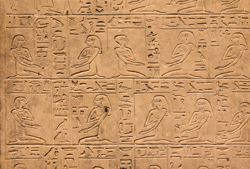 Hieroglyphic carvings on the exterior walls of an ancient egyptian temple