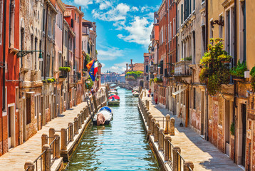 Fototapeta na wymiar Street in Venice with canal boat and blue sky white cloud