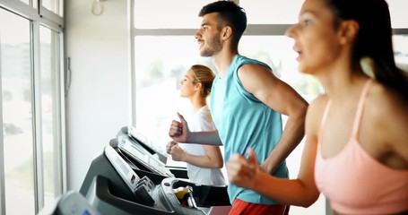 Group of friends exercising on treadmill machine