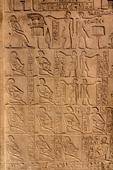 Fototapeta na wymiar Hieroglyphic carvings on the exterior walls of an ancient egyptian temple