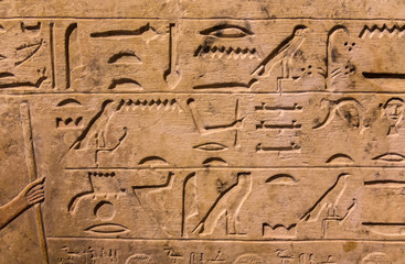Hieroglyphic carvings on the exterior walls of an ancient egyptian temple
