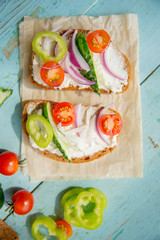 Sandwich with herb pesto and edible nasturtium flowers
