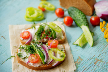 Fototapeta na wymiar Sandwich with herb pesto and edible nasturtium flowers