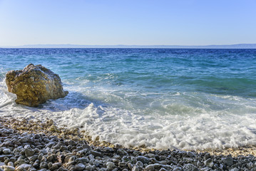Sea beach. Sea waves crashing against the rocks on the coast.