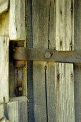 Old doorbell made of wood. The door of an old cellar