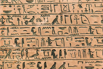 Hieroglyphic carvings on the exterior walls of an ancient egyptian temple