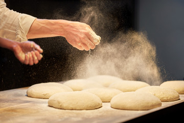 chef or baker cooking dough at bakery