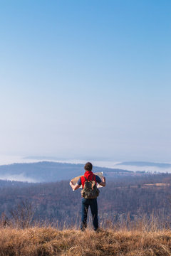 Man Looking At Map While On An Overlook