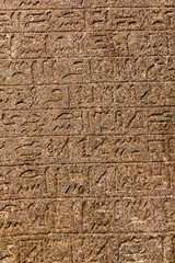 Hieroglyphic carvings on the exterior walls of an ancient egyptian temple
