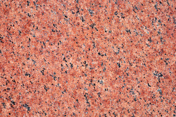 The background of a red granite wall.