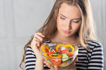 young beautiful woman eating healthy food - salad