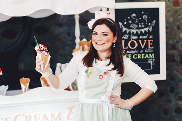 Young girl selling ice cream in a store.