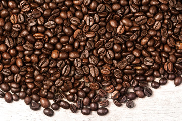 Fresh Coffee beans background macro. Dark Roasted coffee beans textured wallpaper for your design with copy space.