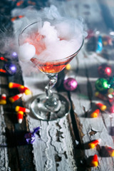 Halloween: Orange Potion In Martini Glass Surrounded By Candy