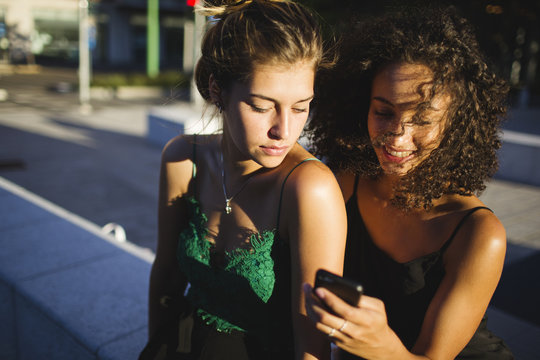 Female friends looking at the cell phone
