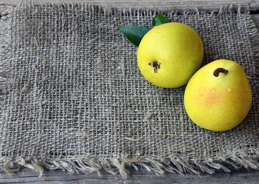 Fresh ripe organic pears on burlap cloth background.Healthy eating,diet,raw food and nutrition concept.Selective focus.