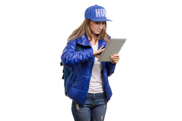Beautiful young girl travels with a backpack and tablet