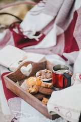 Naklejka na ściany i meble Cozy autumn picnic with tea and cookies