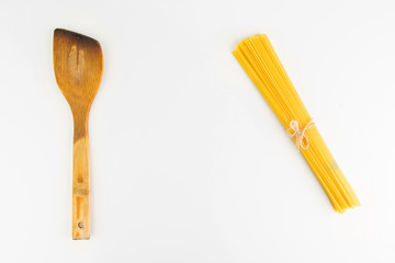 Kitchen Utensil  With Raw Italian Spaghetti Pasta On White Background Closeup