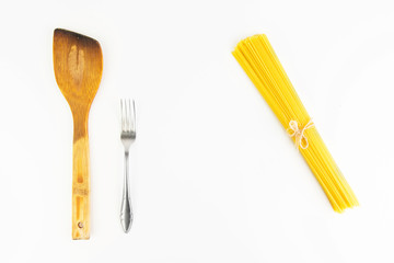 Kitchen Utensil  With Raw Italian Spaghetti Pasta On White Background Closeup