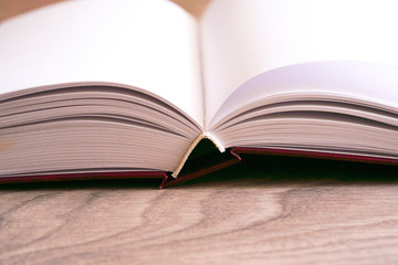 Open book on wooden background. Back to school.