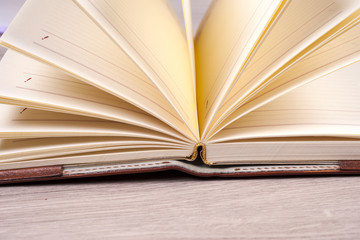 Open book, hardback books on bright colorful background.