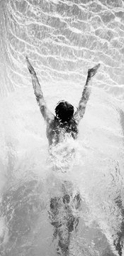 Black and white image of a swimmer shot from above