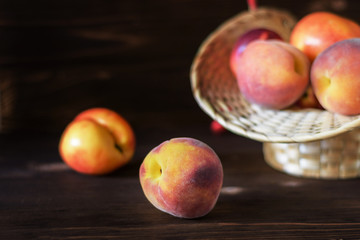 Two mature peaches on a wooden background