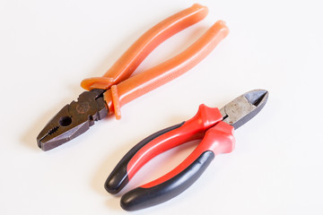 A couple of tools for electro installation. Cutters and pliers on a light background. A couple of hand tools.