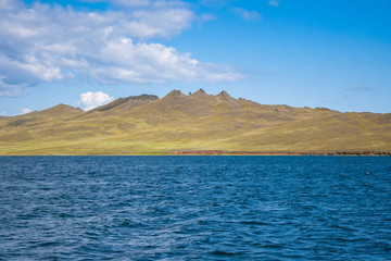 Olkhon island in lake Baikal. Mountain view in Sunny day. Water, mountain, sky.