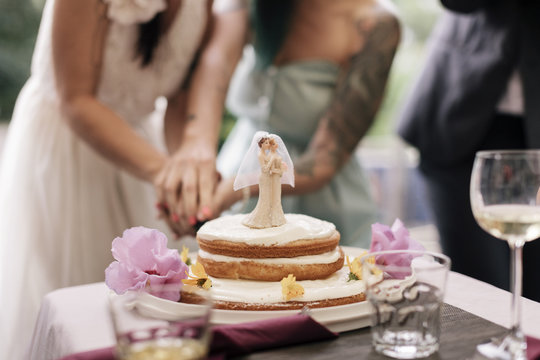 Close up of Brides cutting Cake