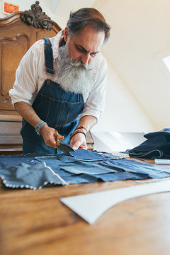 Indoor Portrait of Fashionable Senior Tailor Working on Boro Patchwork