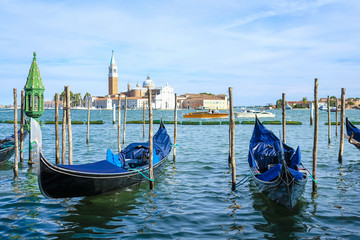 Fototapeta na wymiar Venice, Italy, May, 31, 2017: gondolas on a channel in Venice, Italy