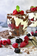 No baked brownie cheesecake with fresh berries in a glass.