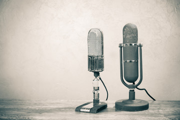 Old retro big ribbon microphones from 50s on table. Vintage style sepia photo