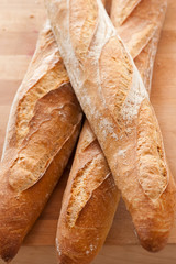 isolated baguette on wooden table